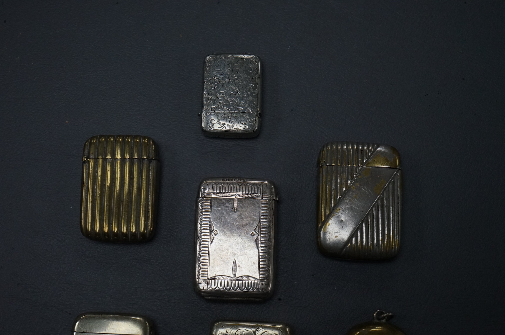 Seven base metal vesta cases, largest 6cm high
